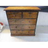 A Victorian walnut miniature/salesman sample chest of two short and three long drawers, together