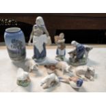 Royal Copenhagen porcelain models and figures to include a woman feeding a cow, a girl, a woman with