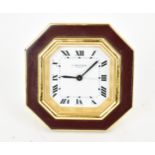 A Cartier manual wind, gilt brass and burgundy enamel travel clock having a white enamel dial with