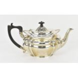 A George V silver teapot by Josiah Williams & Co, London 1922, with moulded border, ebony finial and