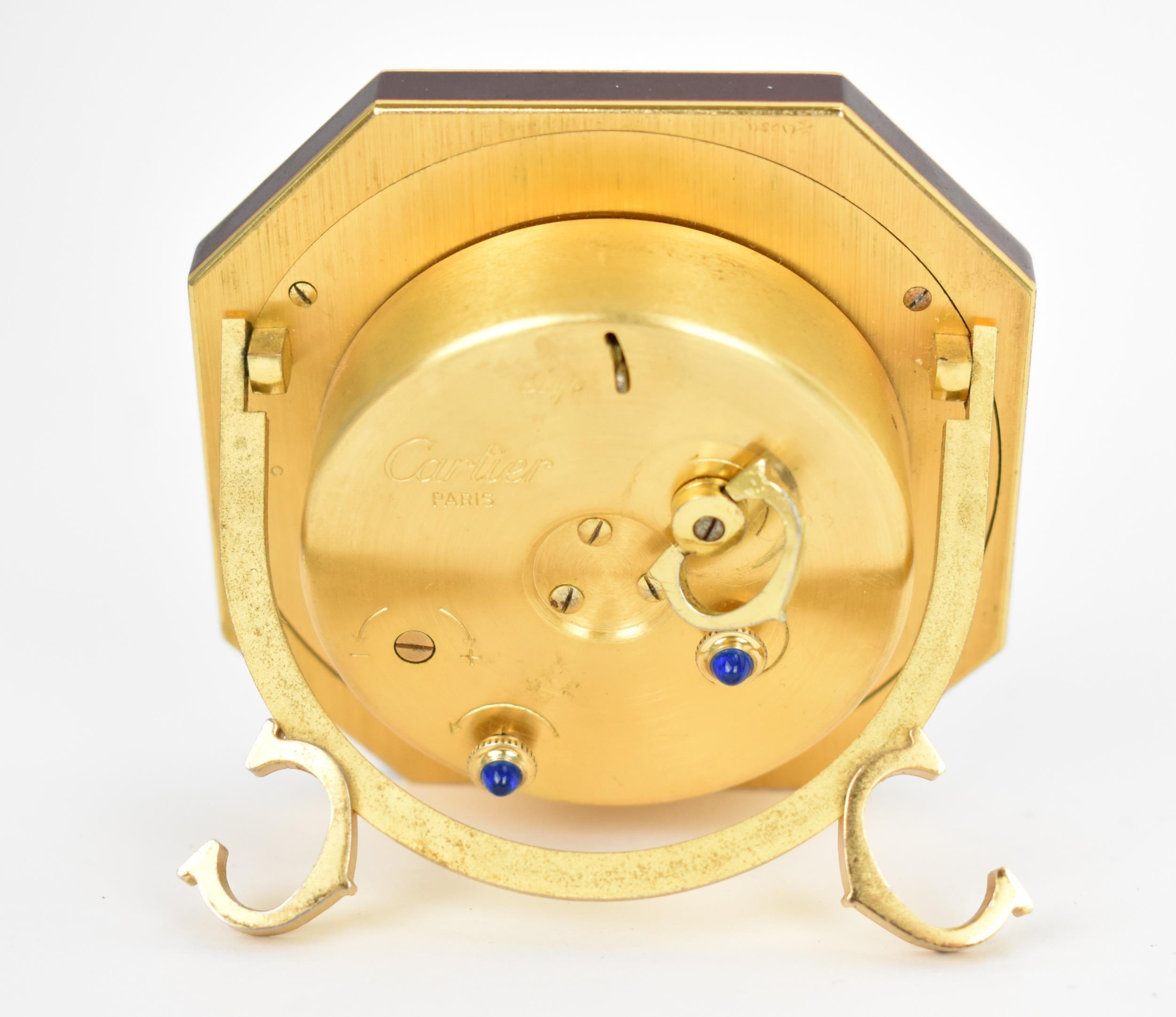 A Cartier manual wind, gilt brass and burgundy enamel travel clock having a white enamel dial with - Image 3 of 5