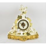 A late 19th century porcelain mantle clock, decorated with cherubs eating grapes on a gilded base,