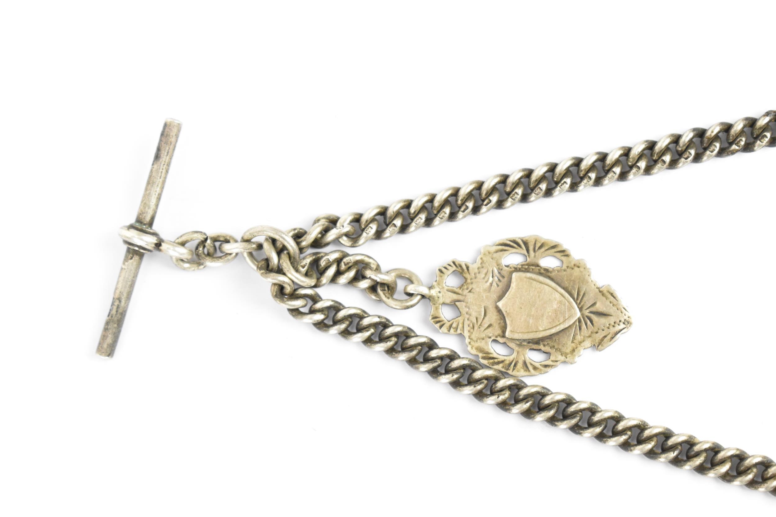 A late 19th/ early 20th century silver curb link pocket watch chain having a T-bar, silver fob and - Image 3 of 5