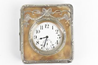An early 20th century Goliath nickel plated 8 day clock in a fitted silver and leather case, the