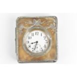 An early 20th century Goliath nickel plated 8 day clock in a fitted silver and leather case, the