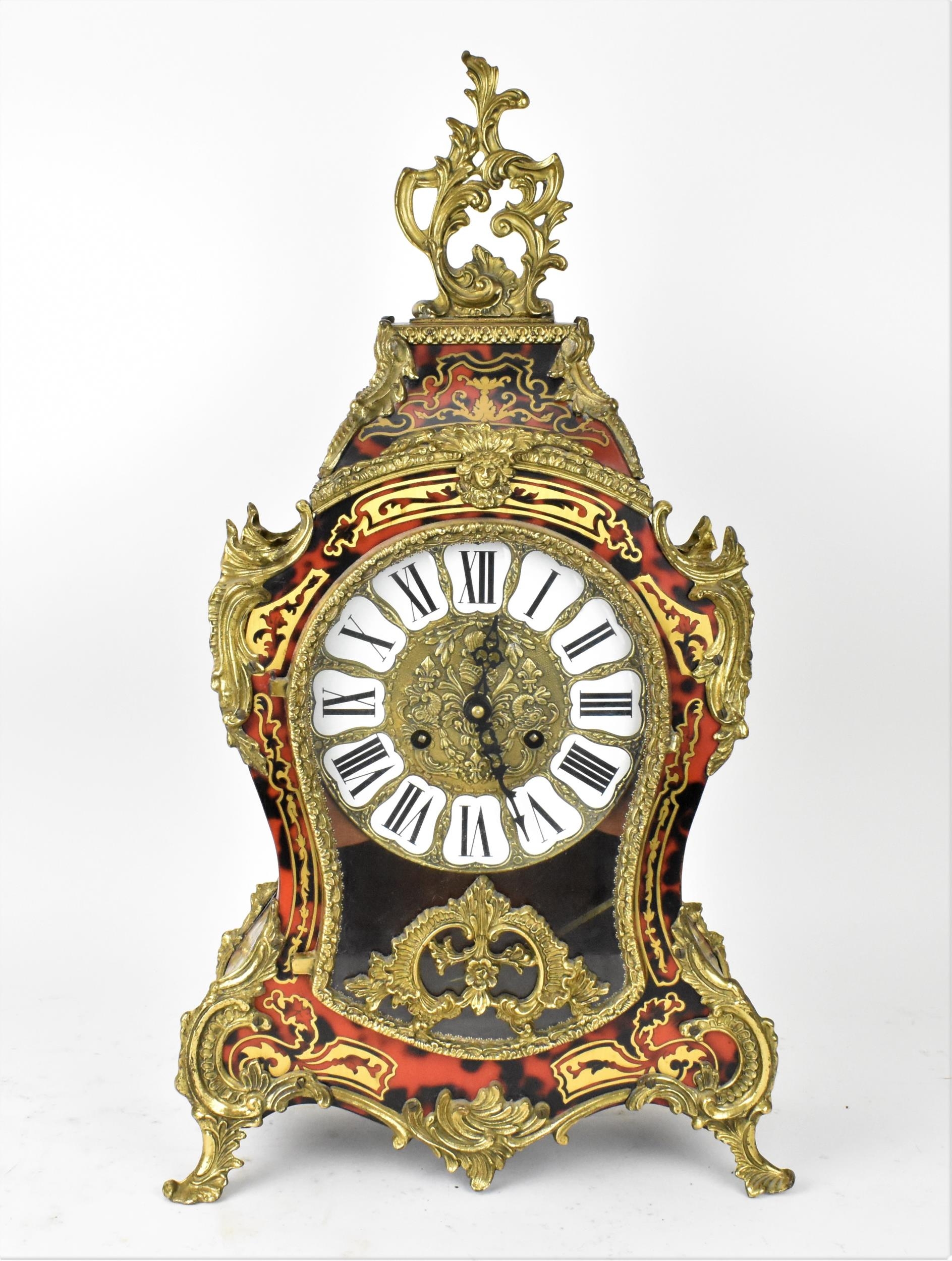 A 20th century French boulle work mantle clock having applied gilt metal C scroll and floral