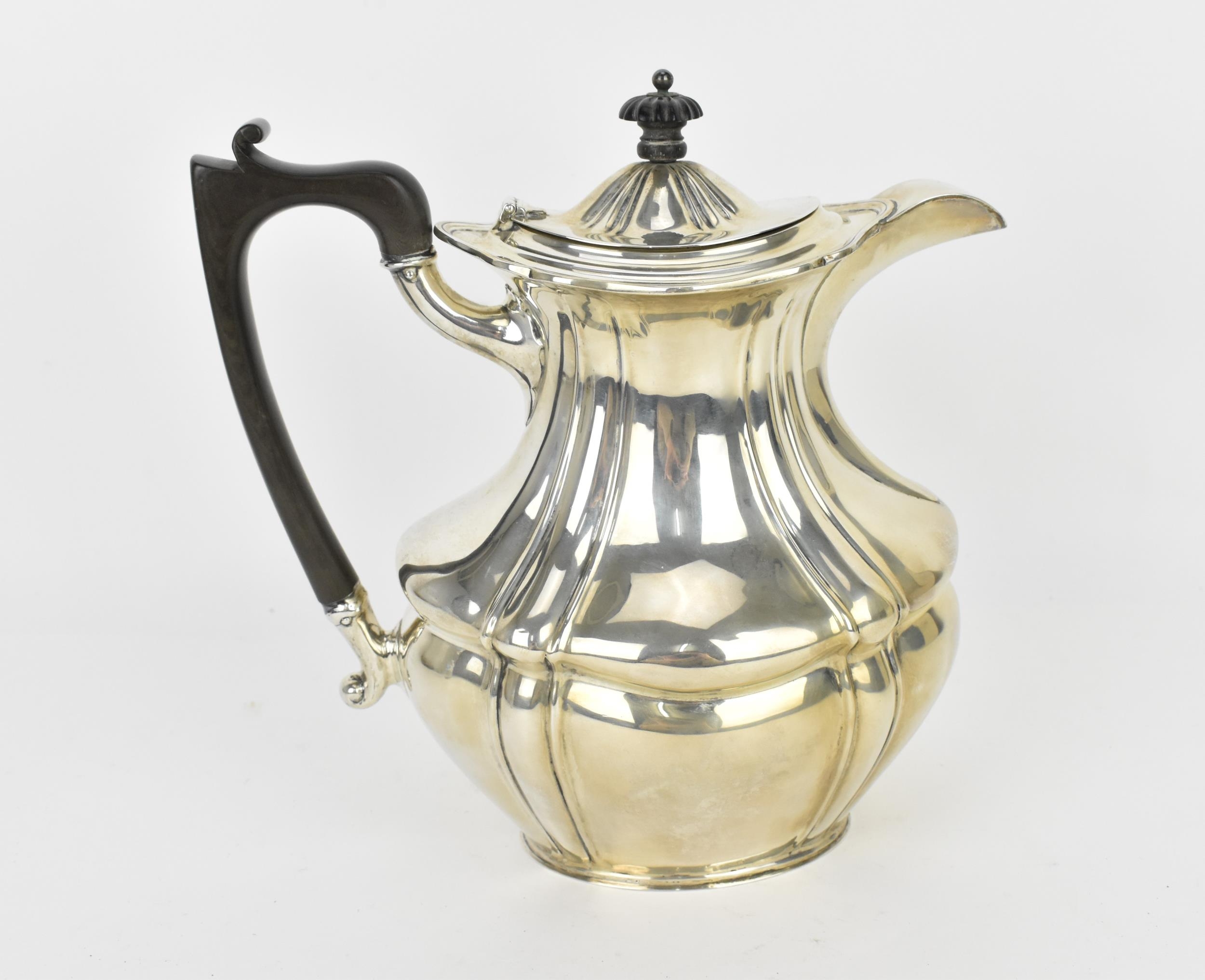 A George V silver coffee pot by Josiah Williams & Co, London 1922, with moulded border, ebony finial