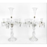 A pair of Baccarat five light candelabra, with central petal rim trumpet vase above five twist