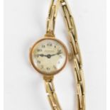 An early 20th century ladies 9ct gold cased manual wind wristwatch having a silvered dial signed