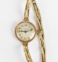 An early 20th century ladies 9ct gold cased manual wind wristwatch having a silvered dial signed