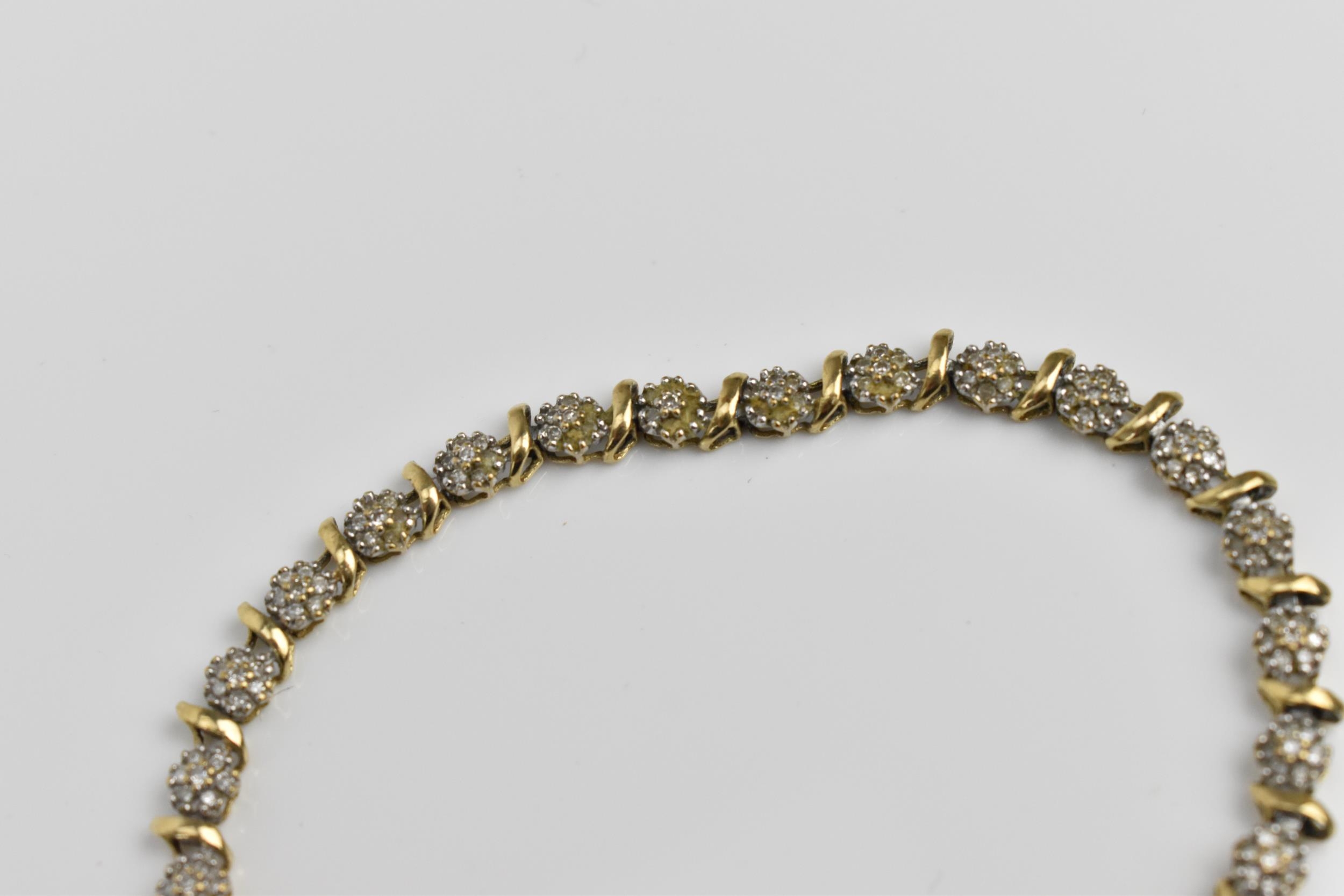 A 9ct yellow gold and diamond bracelet, designed with twenty-seven floral diamond clusters, with - Image 5 of 7