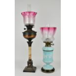 Two early 20th century oil lamps, to include one with blue opaline body with pate-sur-pate vine leaf