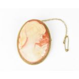 A 9ct yellow gold mounted cameo brooch, the carved shell depicting a lady, the mount with twist