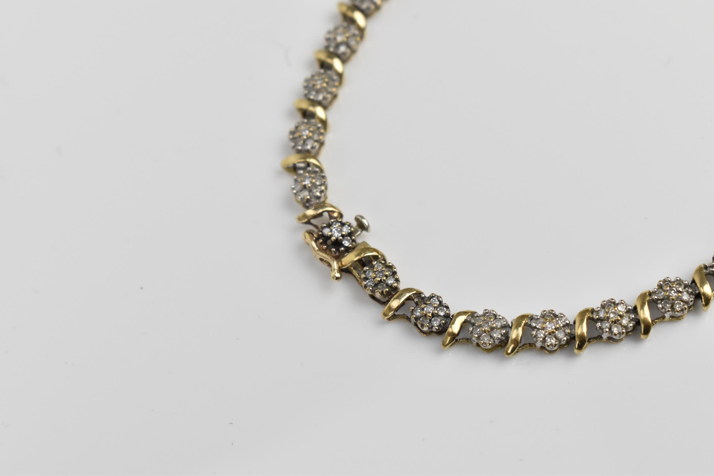 A 9ct yellow gold and diamond bracelet, designed with twenty-seven floral diamond clusters, with - Image 3 of 7