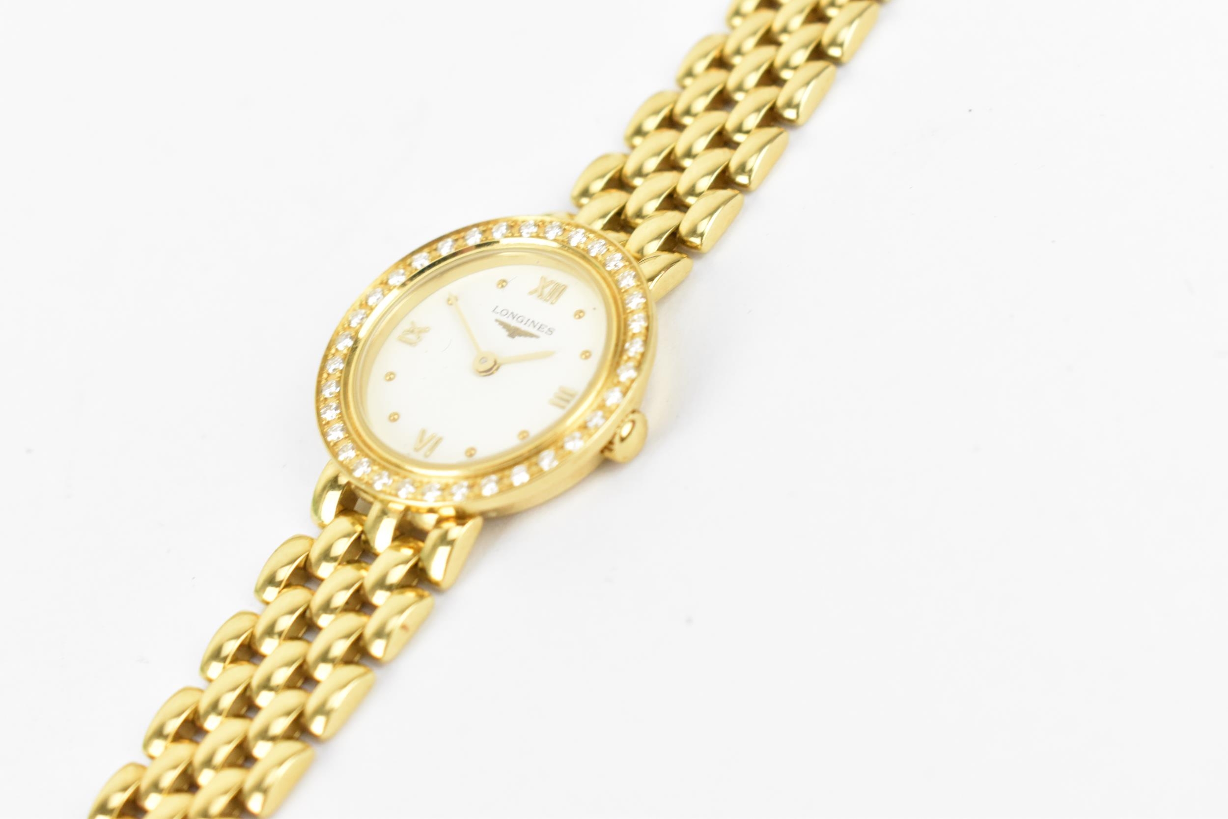 A Longines, quartz, ladies 18ct gold wristwatch having a diamond set bezel, white enamel dial with - Image 2 of 4