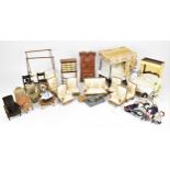 A collection of doll house furniture and dolls, to include two four poster beds, one with