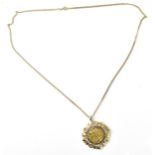 A 9ct yellow gold flat curb link chain necklace with a George V, 1911 sovereign coin in a 9ct gold