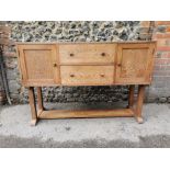 A 1939/40s 'Heals' oak sideboard with two drawers flanked by a pair of doors, over four columns,