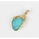 A 15ct yellow gold, black opal and diamond pendant, inset with a central freeform opal in a rub-over