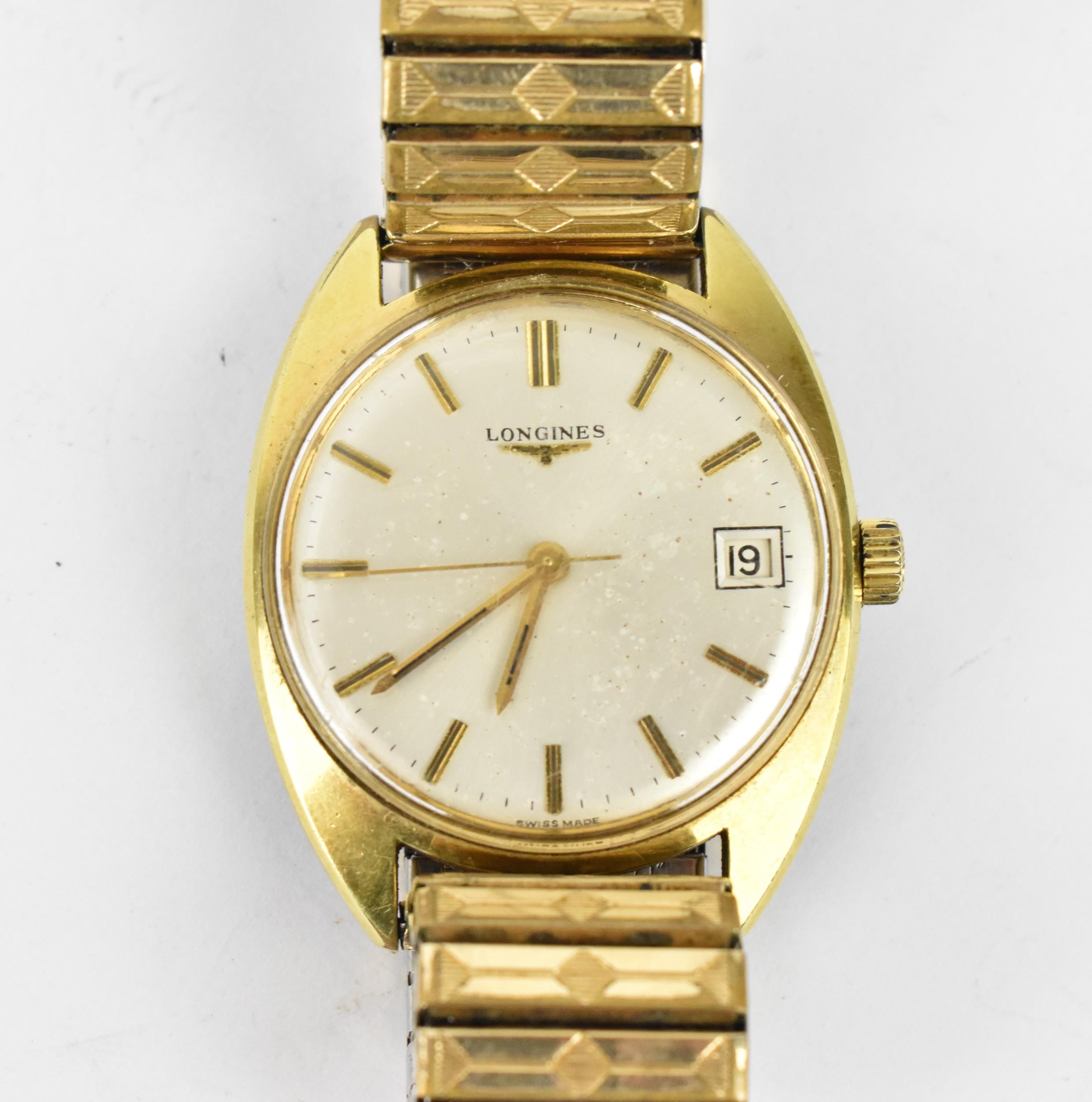 A Longines manual wind, gents, gold plated wristwatch, having a silvered dial with centre seconds,