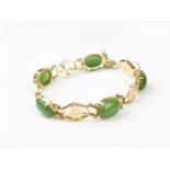 A 14ct yellow gold and green jade bracelet, with Chinese character links separated with jade