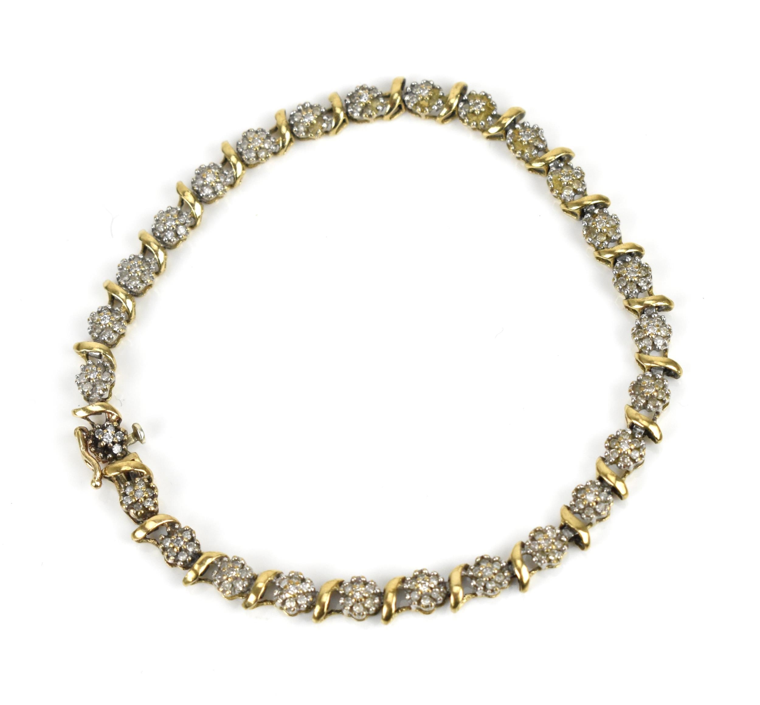 A 9ct yellow gold and diamond bracelet, designed with twenty-seven floral diamond clusters, with
