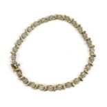 A 9ct yellow gold and diamond bracelet, designed with twenty-seven floral diamond clusters, with