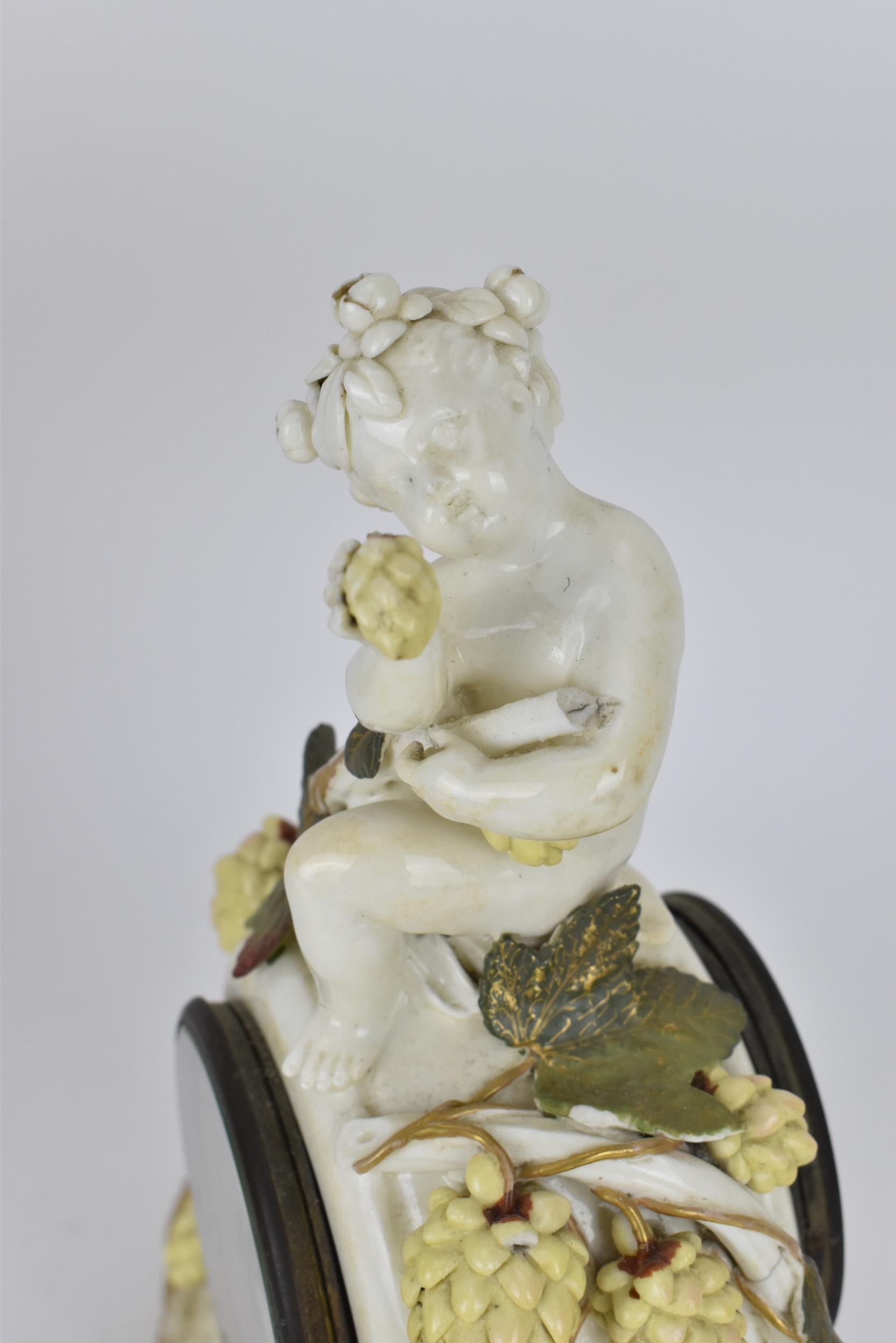 A late 19th century porcelain mantle clock, decorated with cherubs eating grapes on a gilded base, - Image 5 of 7
