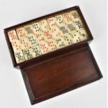 A late 19th/early 20th century Chinese cased set of carved bone and bamboo mahjong style poker deck,
