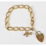 An 18ct yellow gold curb link charm bracelet, with a 9ct yellow gold poodle charm, a 9ct gold