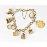 A 9ct yellow gold charm bracelet, with various hanging charms, to include a carousel, bird's cage,