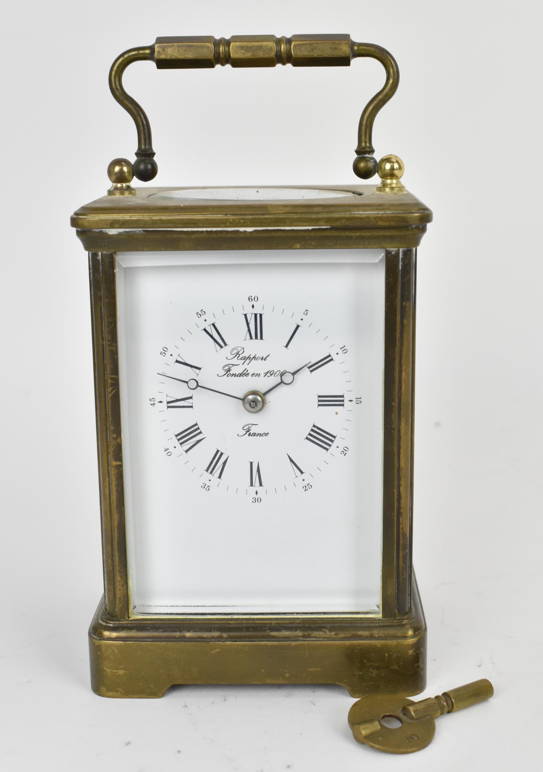 An early/mid 20th century brass cased carriage clock, white enamel dial signed 'Rapport Fondee en