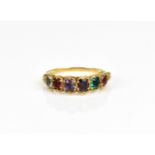A yellow metal multi-gem set dress ring, set with six multi-coloured stones to include amethyst,