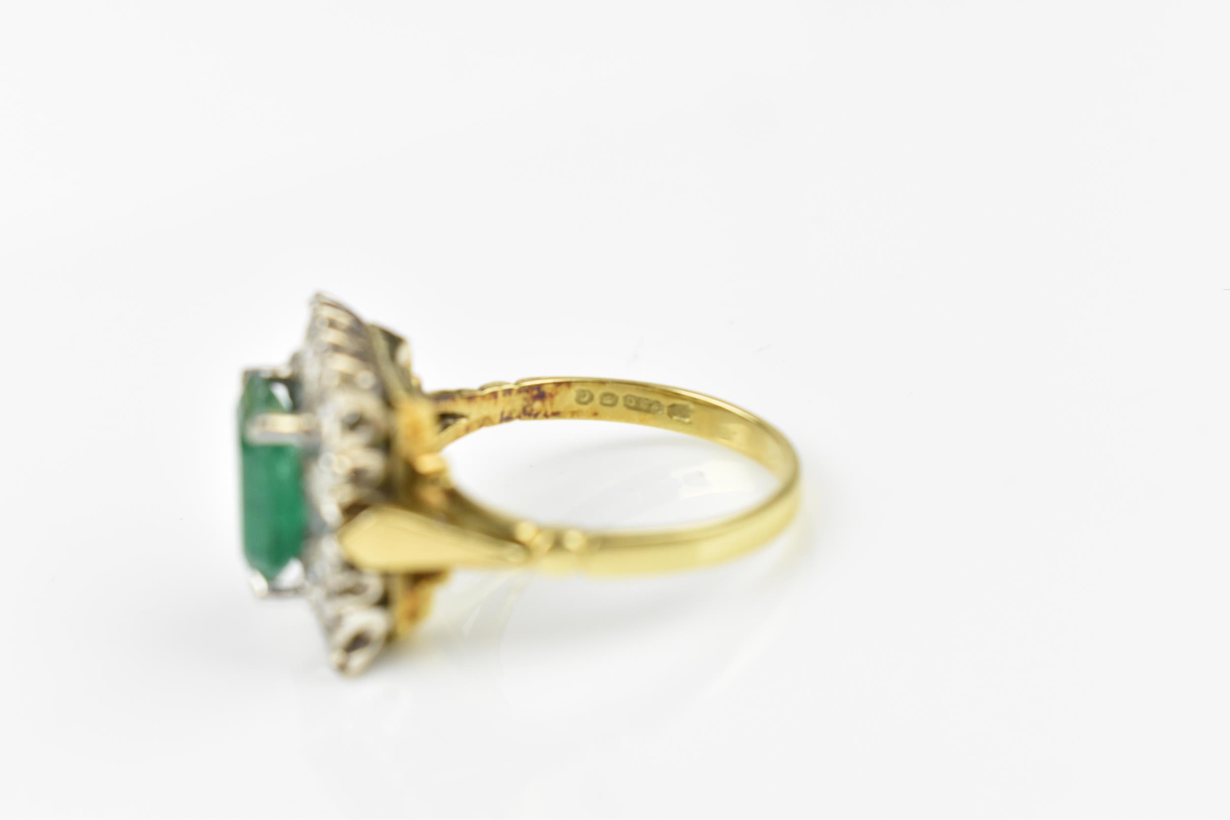 An 18ct yellow gold, emerald and diamond dress ring, with central step cut emerald in a halo of - Image 4 of 7
