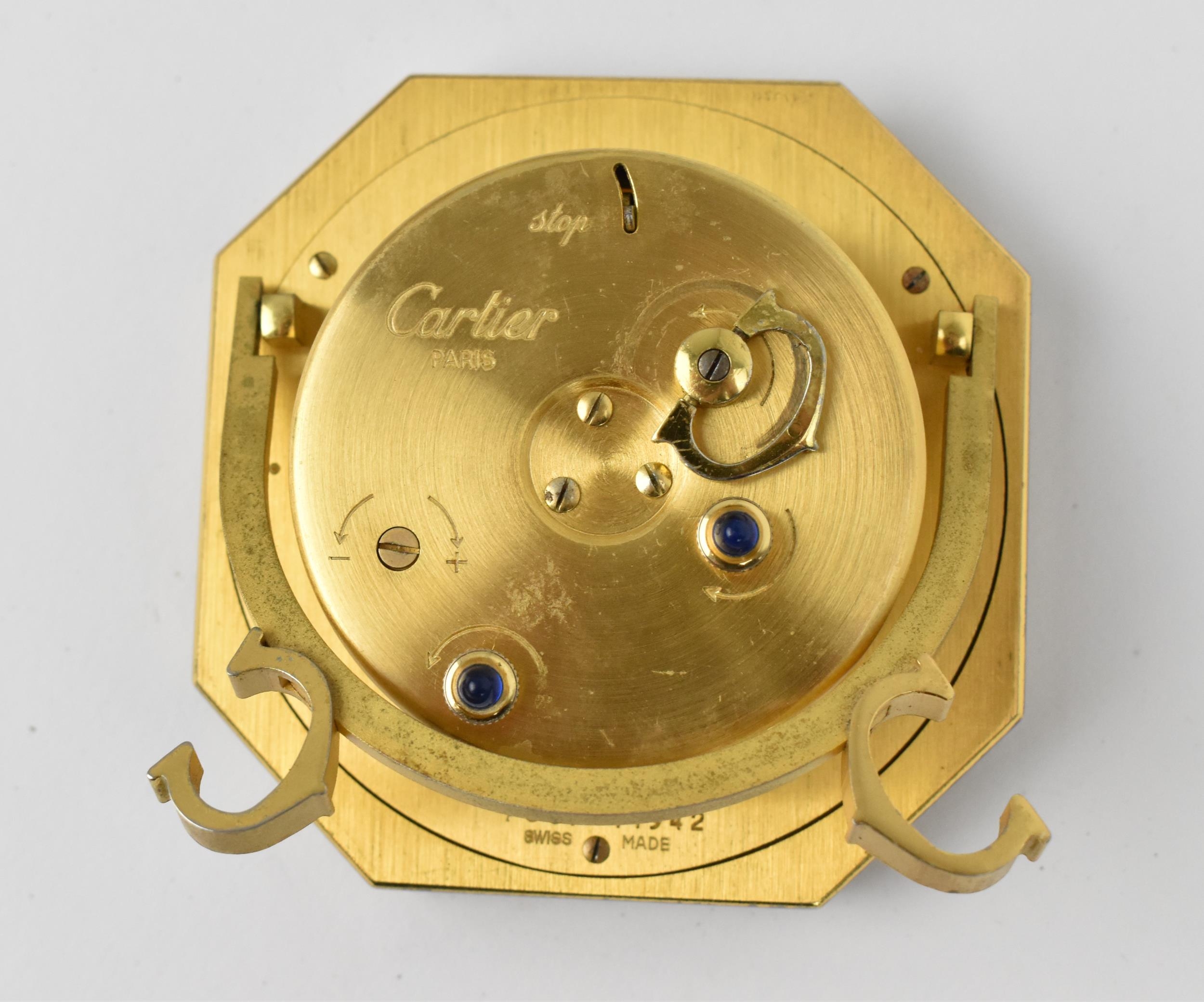 A Cartier manual wind, gilt brass and burgundy enamel travel clock having a white enamel dial with - Image 4 of 5