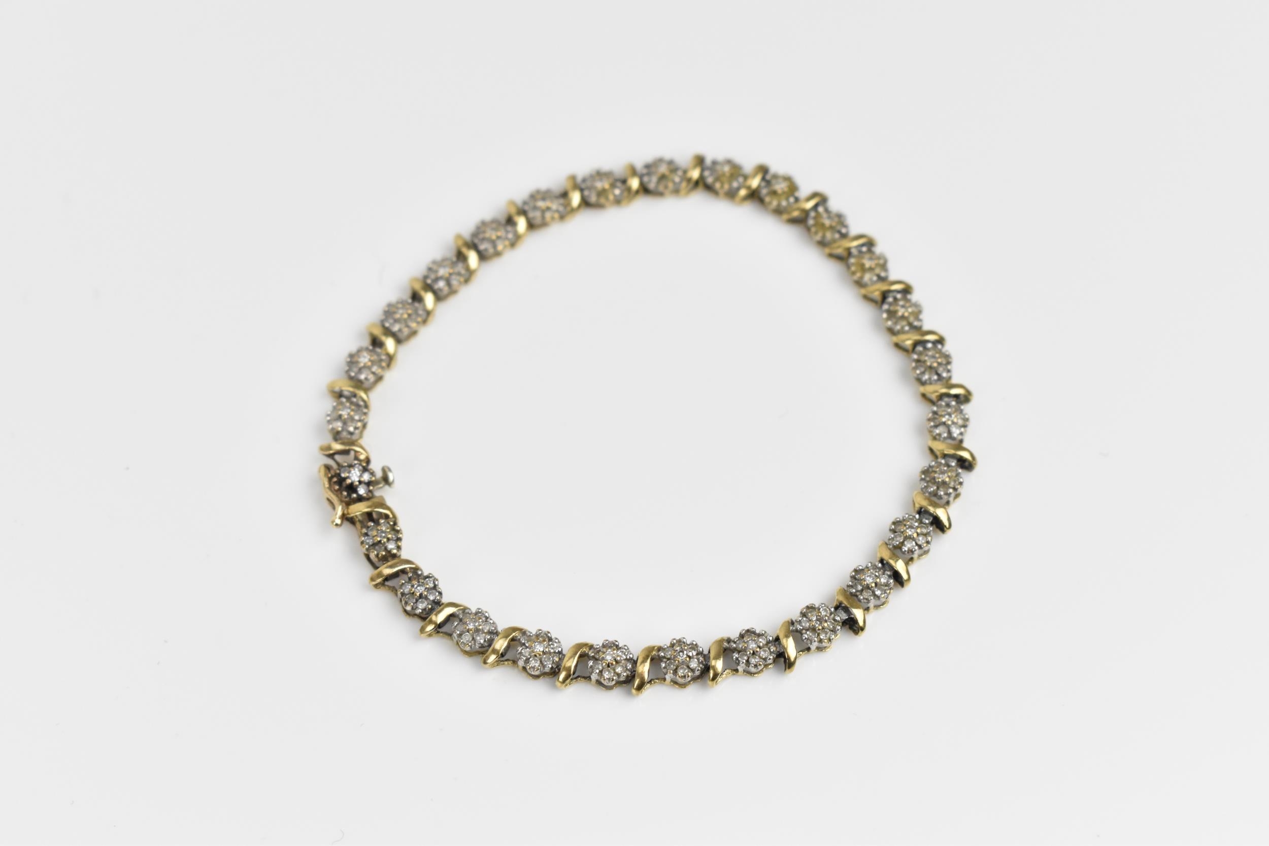 A 9ct yellow gold and diamond bracelet, designed with twenty-seven floral diamond clusters, with - Image 2 of 7