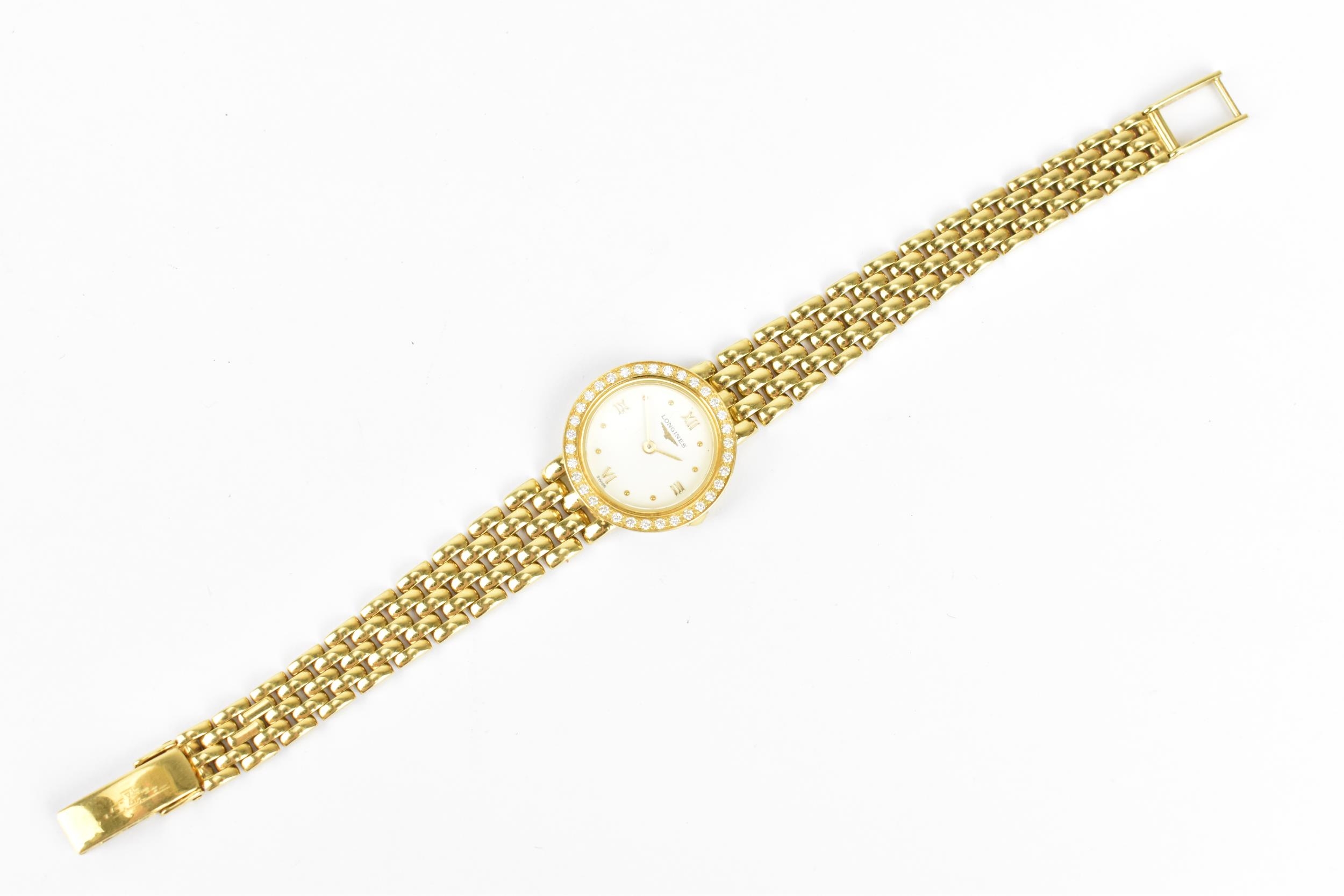 A Longines, quartz, ladies 18ct gold wristwatch having a diamond set bezel, white enamel dial with - Image 3 of 4