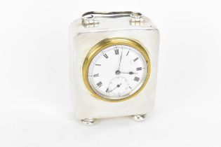 An early 20th century miniature silver cased carriage clock, the case having scroll handle with