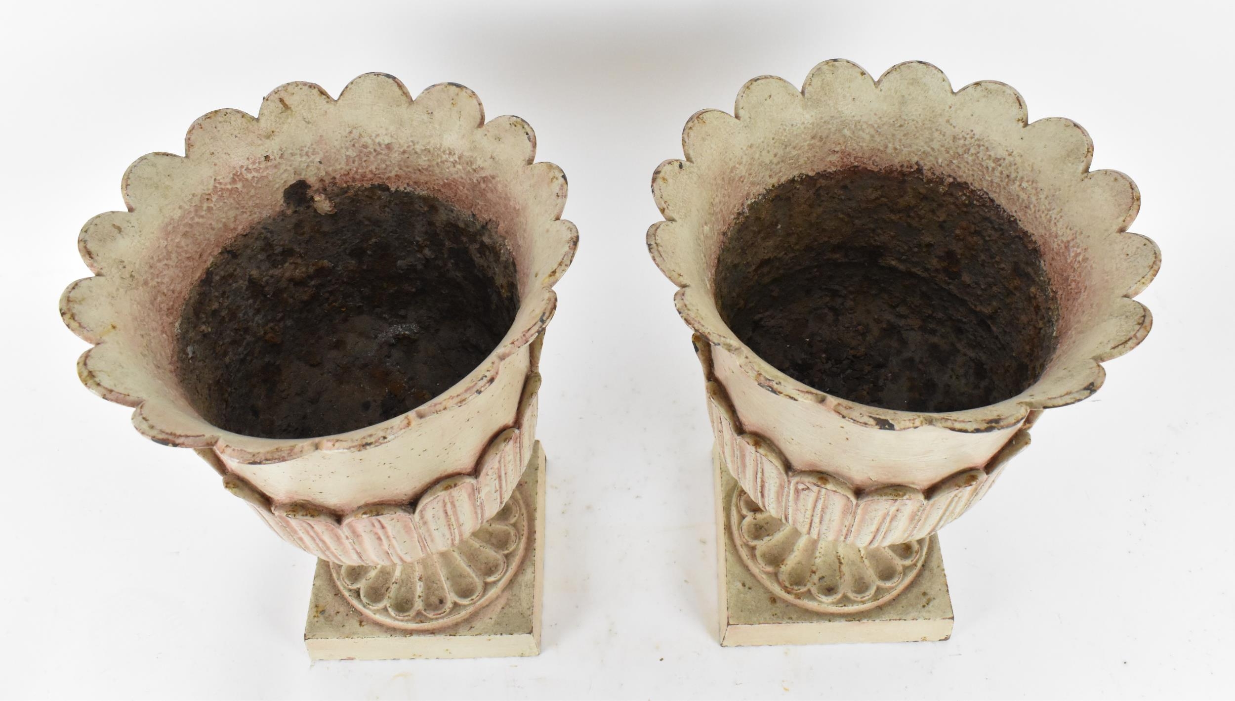 A pair of cast metal garden urns, with everted petal rim, part of the body with cast leaf, on a - Image 2 of 5