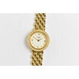 A Longines, quartz, ladies 18ct gold wristwatch having a diamond set bezel, white enamel dial with