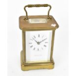 A mid 20th century brass cased carriage clock, white enamel dial with Roman numerals signed