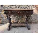 A 19th century Renaissance style carved oak library table, possibly French, with carved dolphin