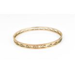 A 9ct rose gold bangle, with pierced frieze design, 8cm diameter, weight 11.5 grams