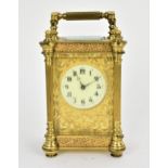 A late 19th/early 20th century gilt metal French miniature carriage clock having turned finials,