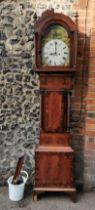 A George III mahogany longcase clock having an arched top with turned finials, twin columns flanking