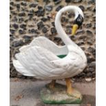 A large early 20th century painted pine garden planter modelled as a swan, with carved detail to the