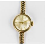 A Tissot manual wind, ladies 9ct gold wristwatch having a silvered dial with baton markers, 9ct gold