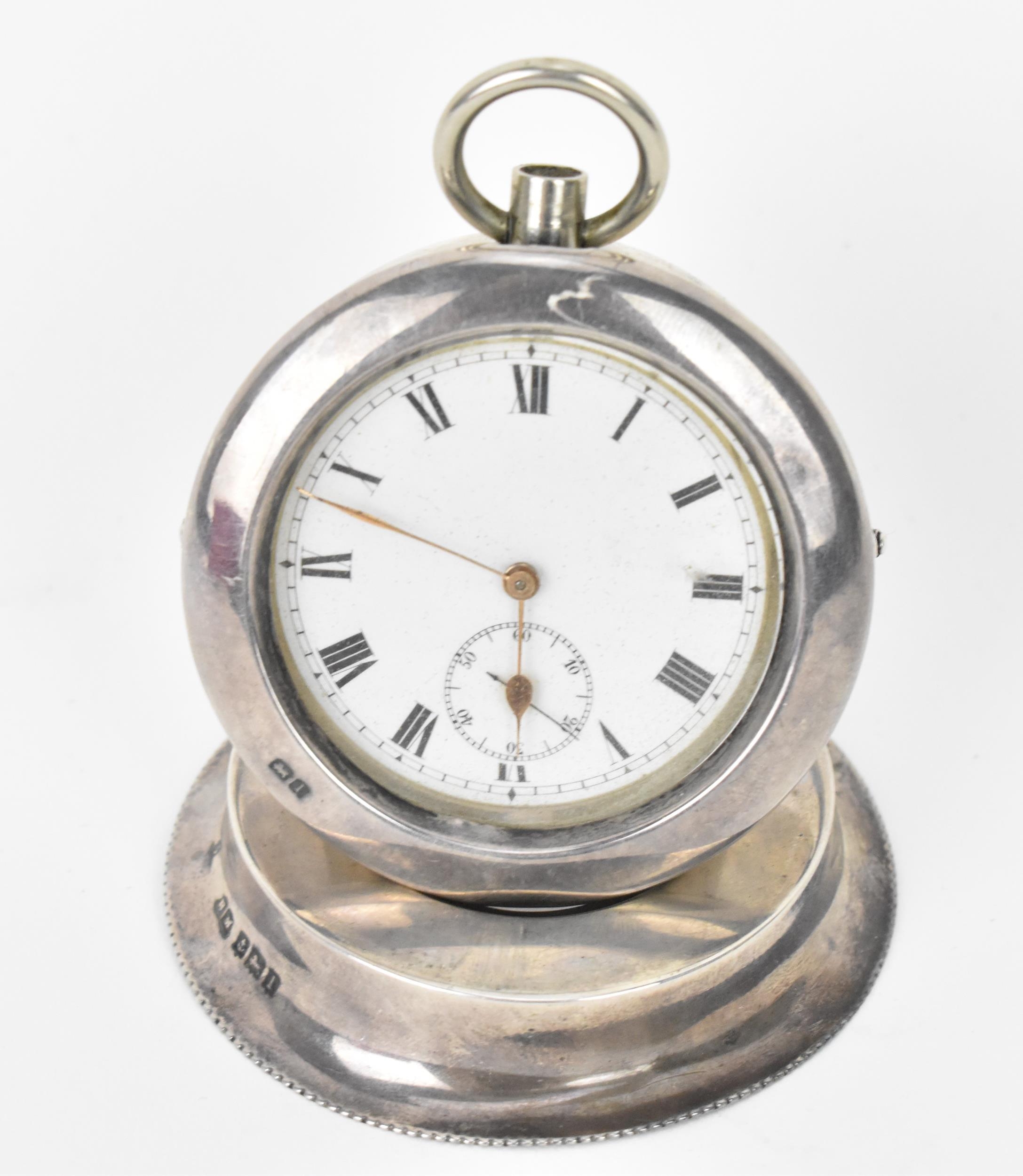 An early 20th century open faced pocket watch having a white enamel dial, with gilt hands, Roman