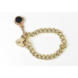A 9ct yellow gold curb link bracelet, with heart shaped padlock clasp and safety chain, and plated