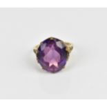 A 9ct yellow gold and alexandrite dress ring, with pierced mount, the shank hallmarked, size N